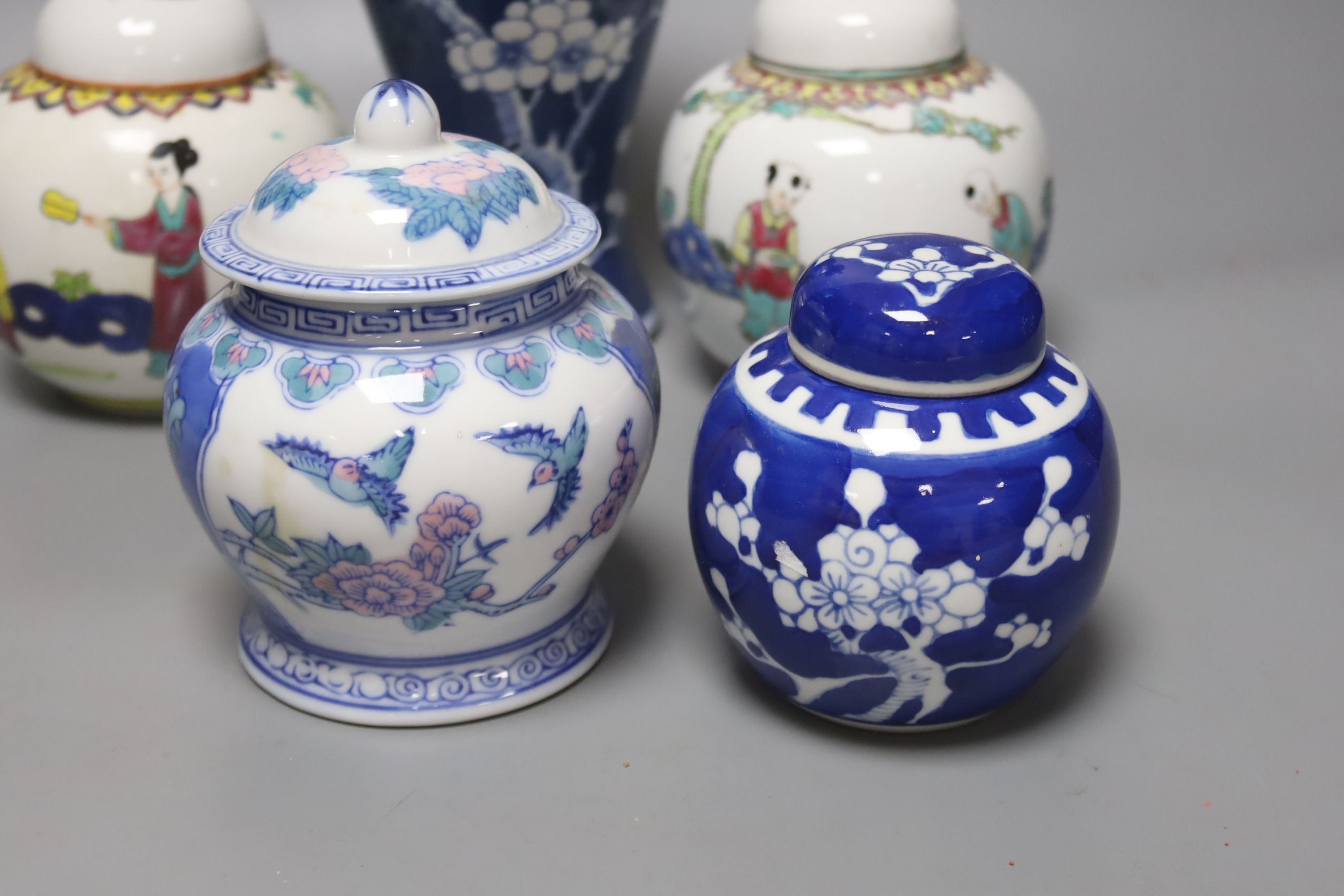 A Chinese blue and white vase and cover, a pair of famille rose jars and covers and two other jars and covers, tallest 27cm